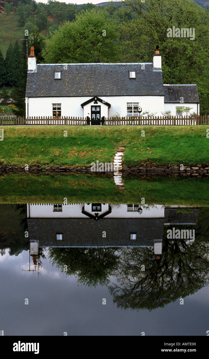Loch Keepers Cottage reflected in still water Bridge of Oich Scottish Highlands Stock Photo