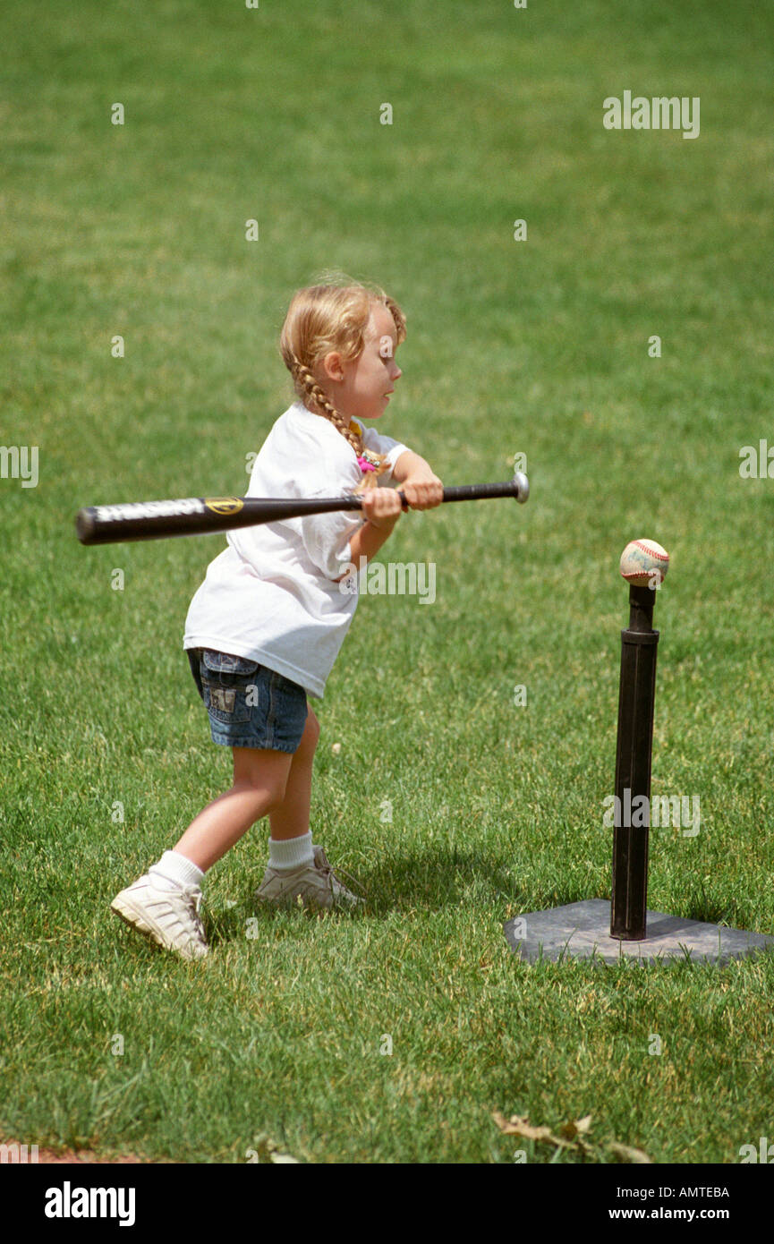 4 and 5 year old boys and girls learn how to hit a ball off of a tee Stock Photo
