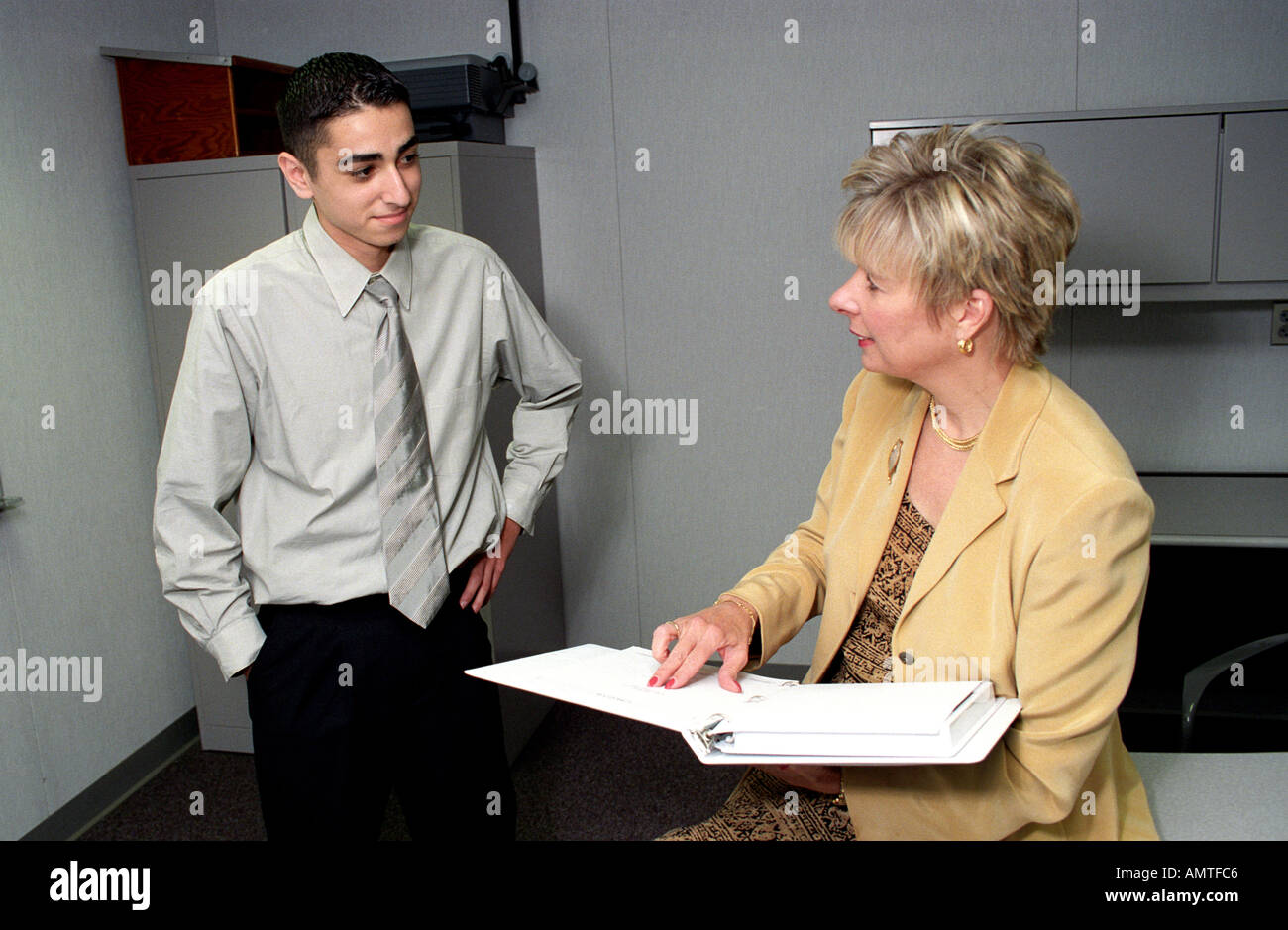 Professional female interviewer converses with ethnic job applicant Stock Photo