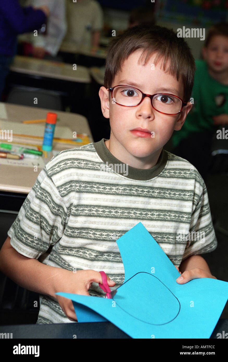1st grade boy wears glasses to improve his vision Stock Photo