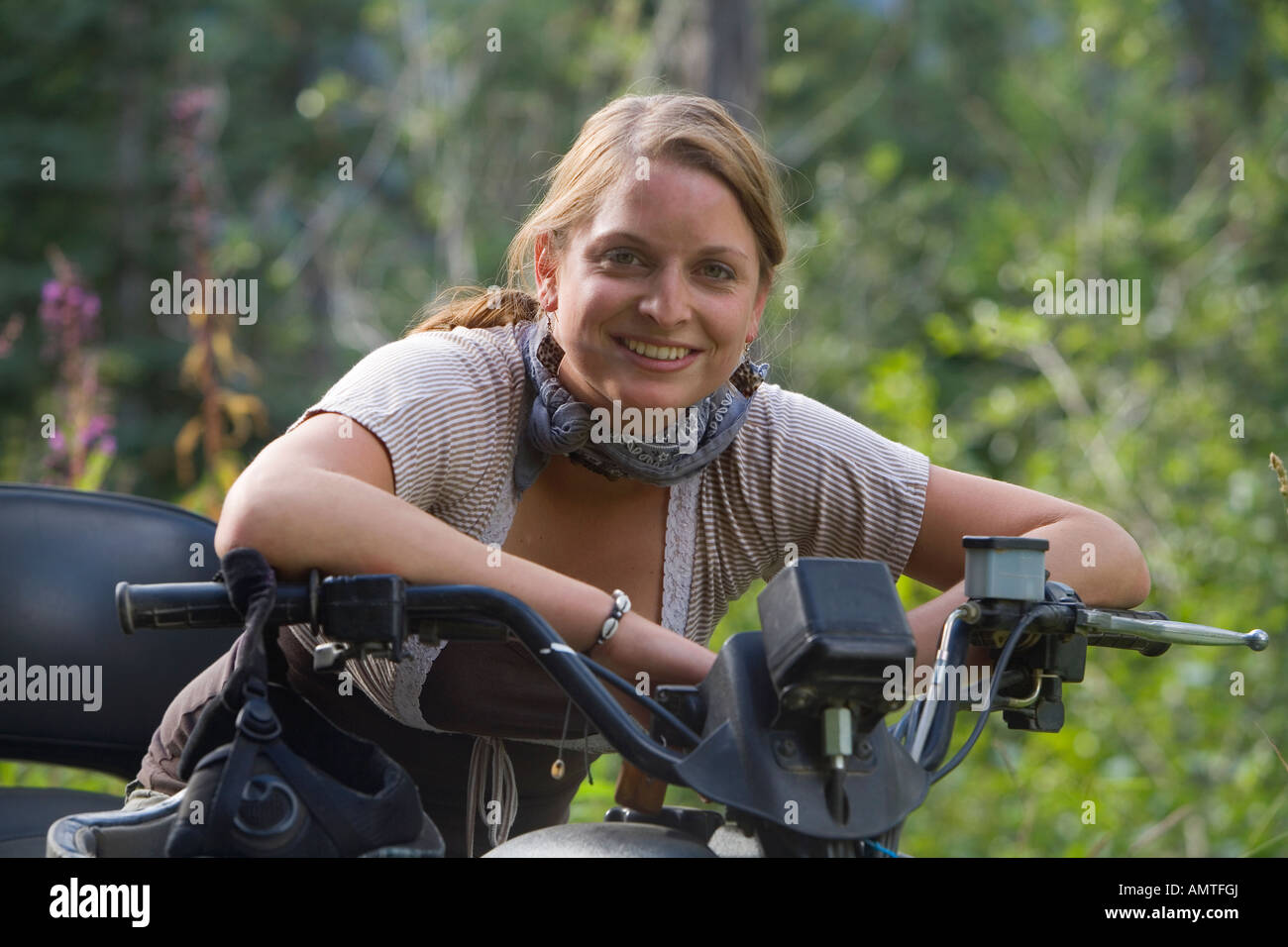 woman riding an all terrain vehicle Stock Photo