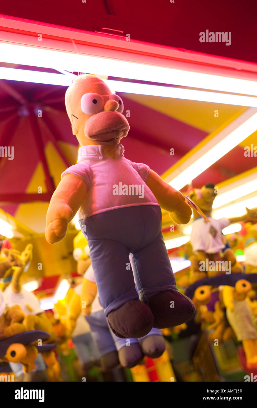 Homer Simpson famous cartoon character doll toy hanging from a funfair stall - a prize for winning Stock Photo