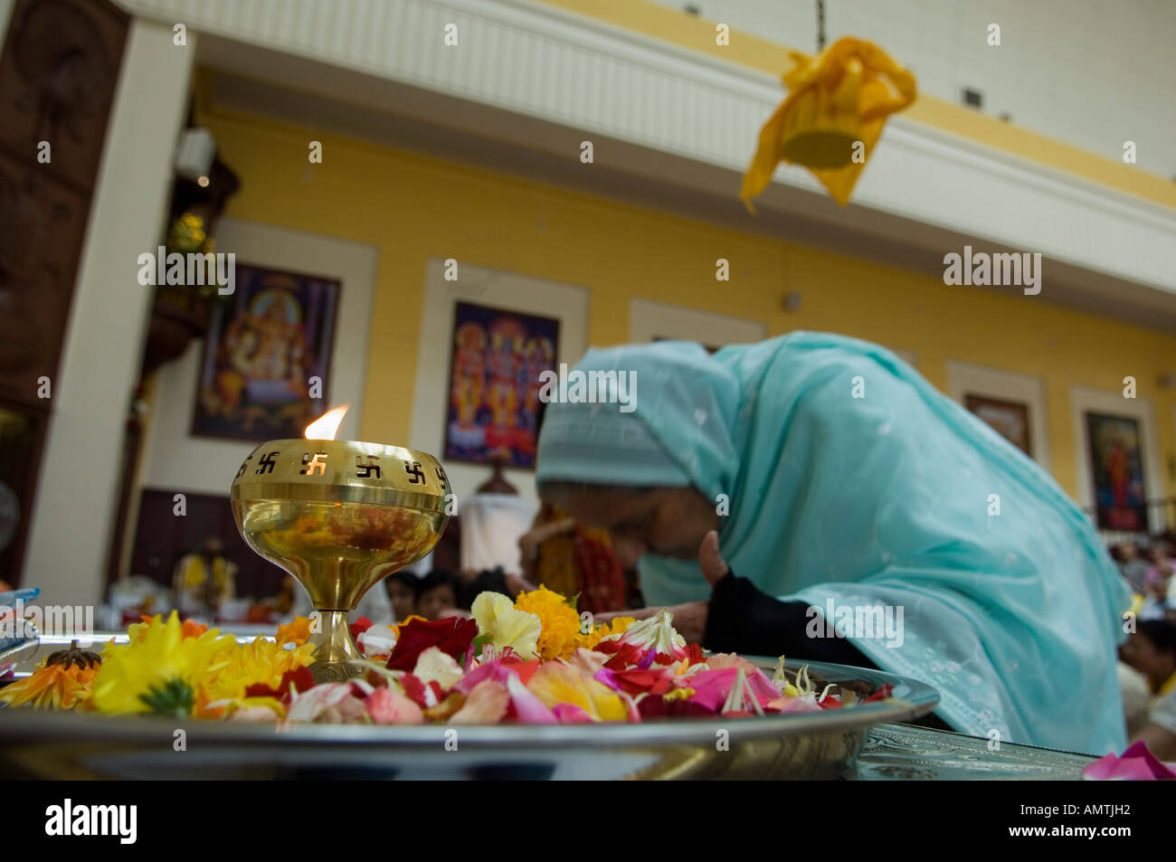 Woman presenting offerings in Hindu temple Stock Photo