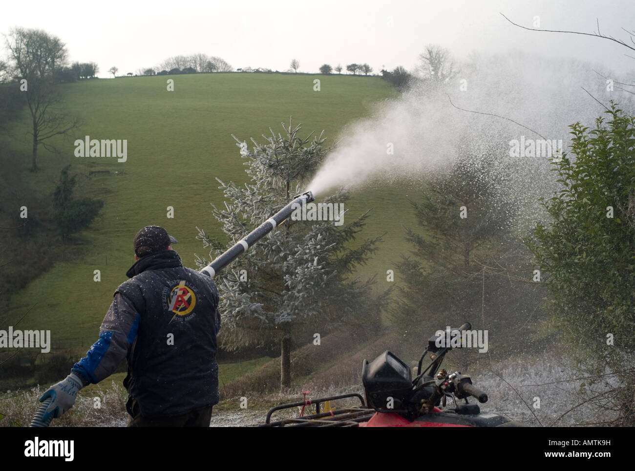 Man working for Snow Business fake snow company spraying farm building