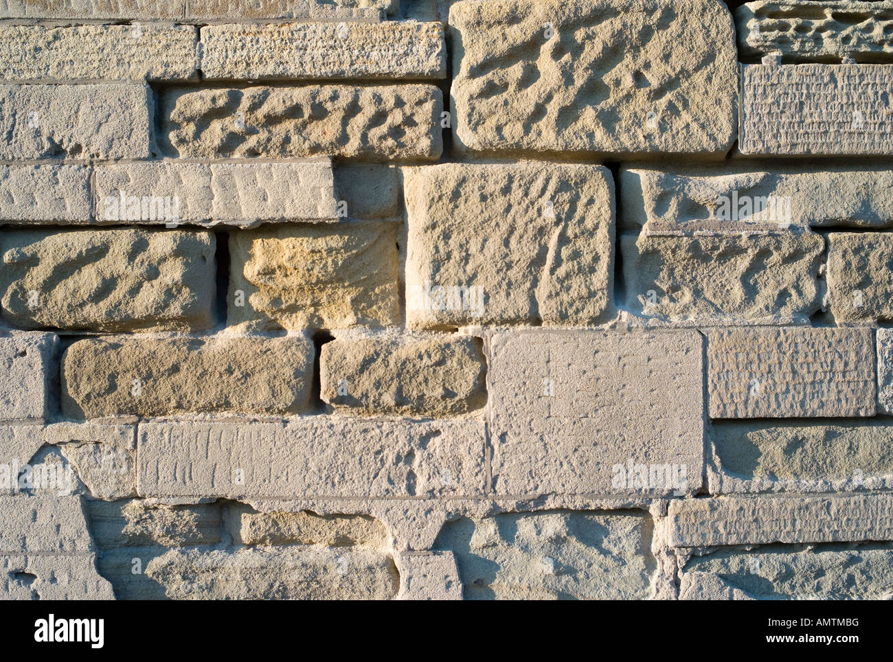 sandstone block exterior wall heavily eroded weathered by wind and acid ...