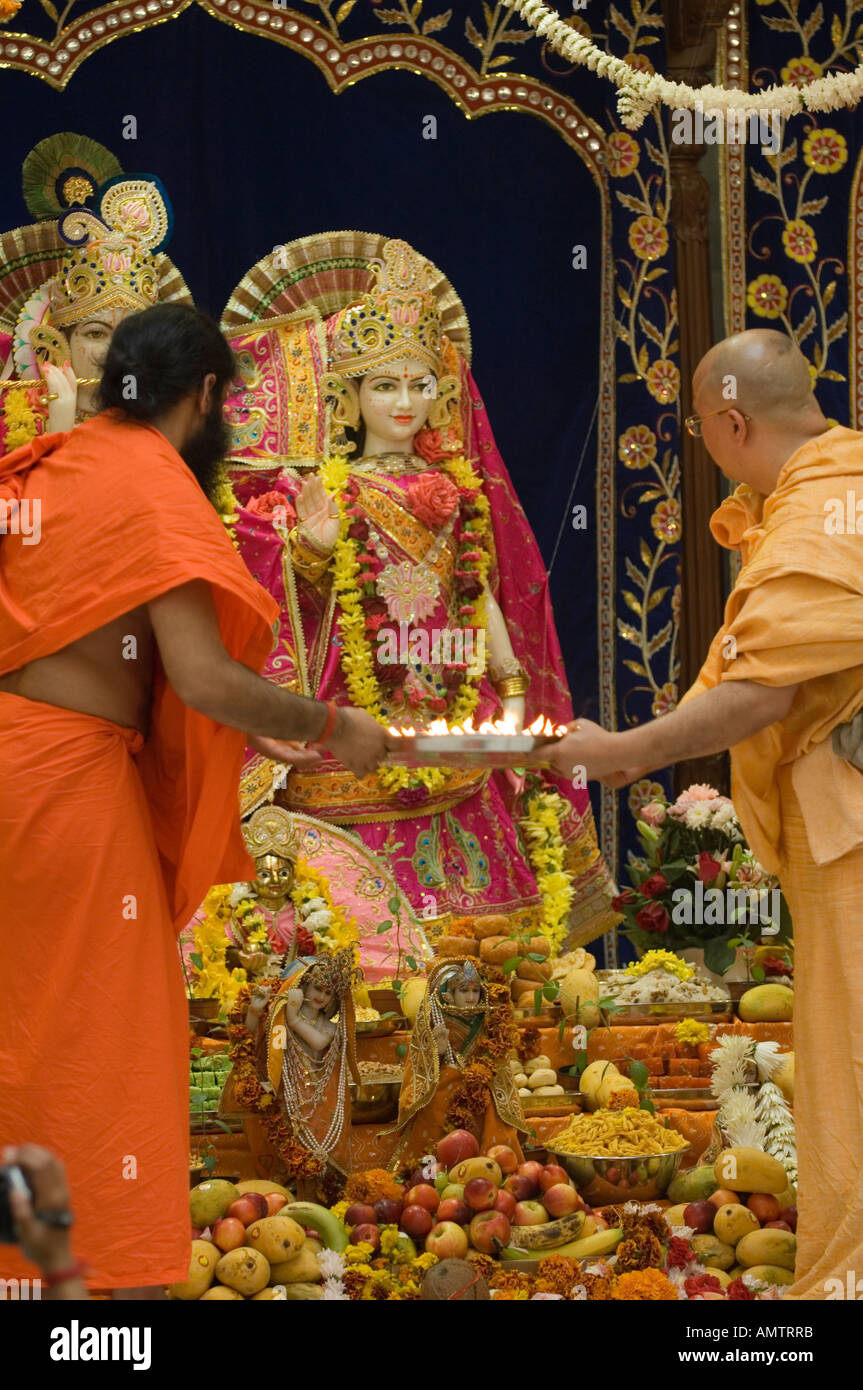Hindu priest presenting offerings to the murtis at temple consecration