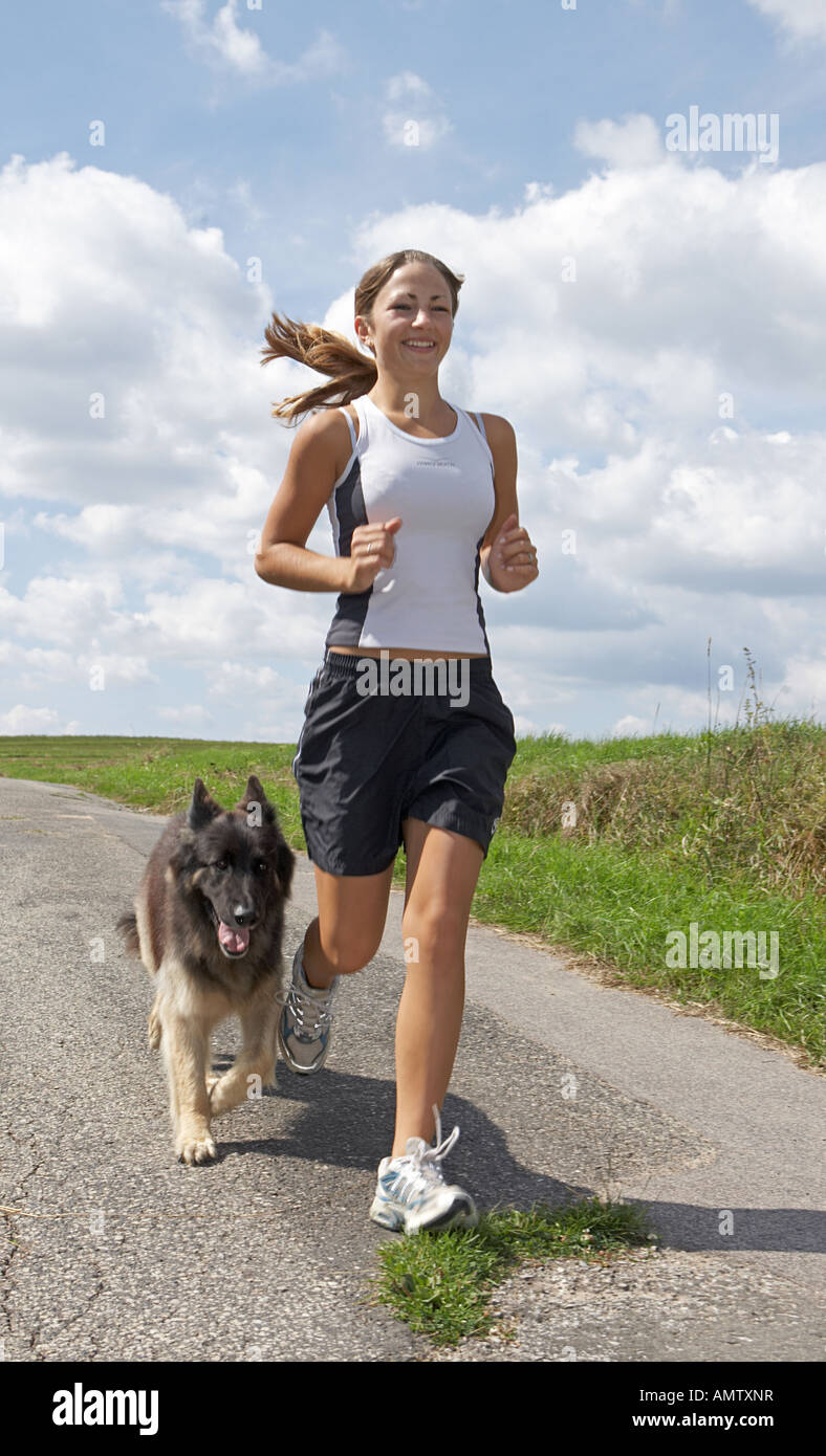Woman and Old German Shepherd dog, jogging Stock Photo Alamy