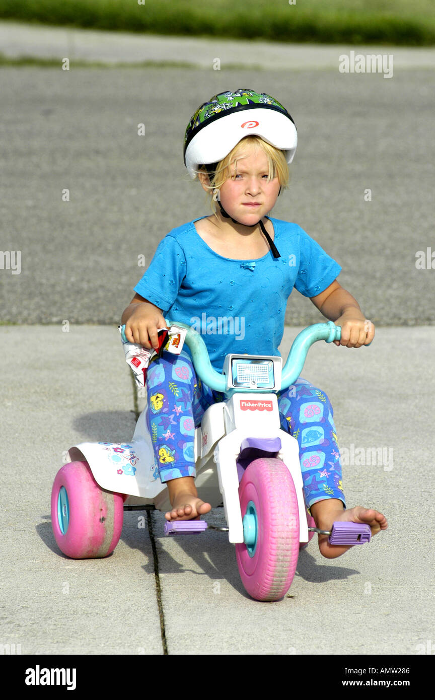 girl riding tricycle
