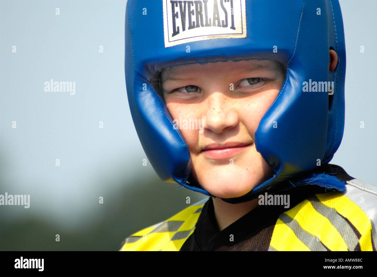 Boy with boxing head gear on for protections from hits and shots to the