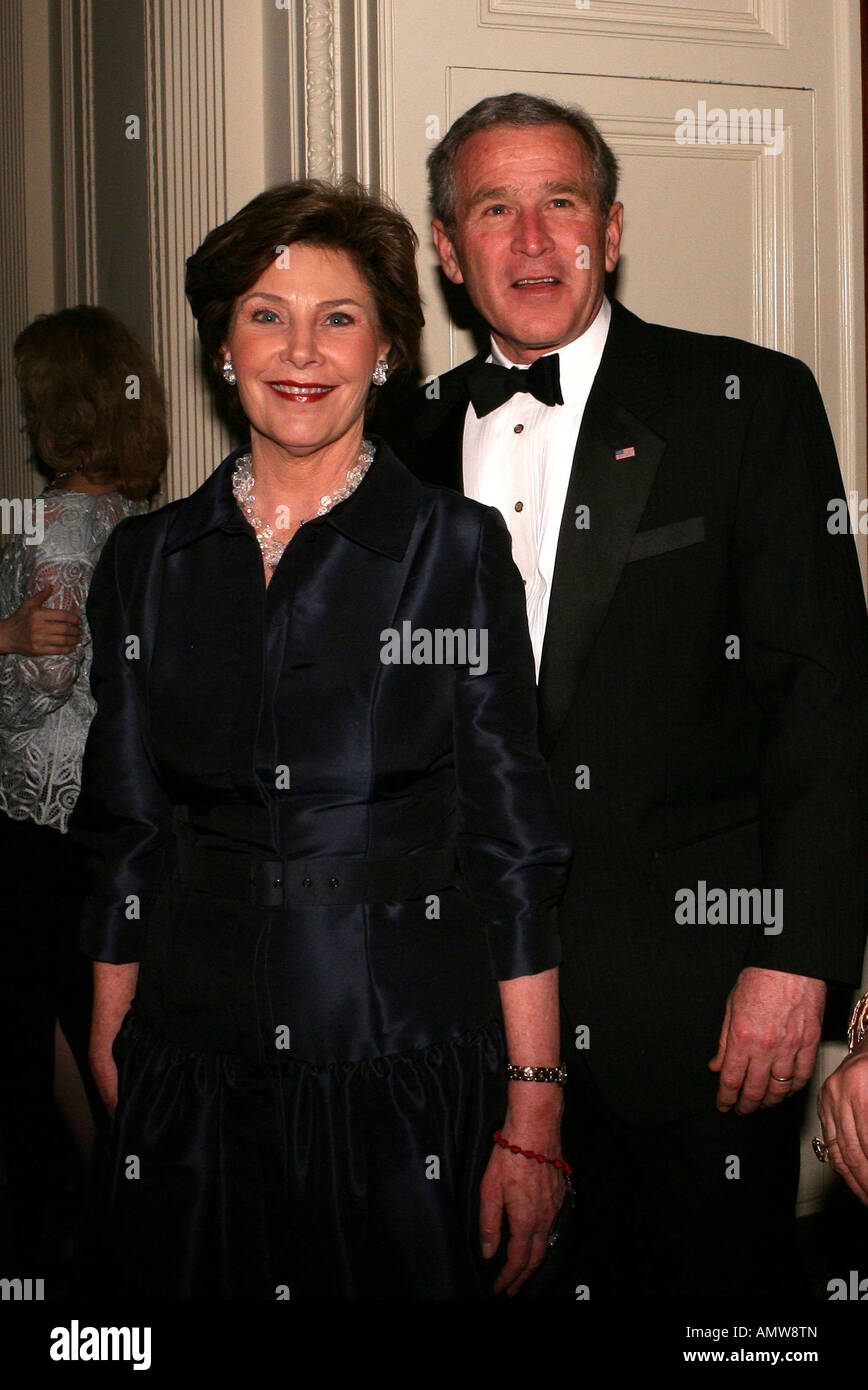 President George W Bush and Laura Bush arrive in the East Room to watch the entertainment for the White House State Dinner Stock Photo