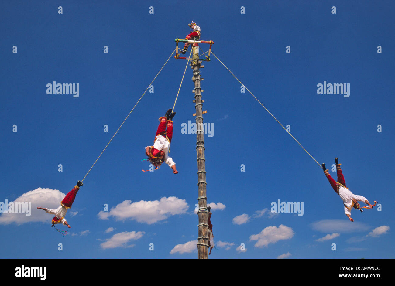 Voladores Totonac people in Papantla Veracruz state flying around a large central pole with ropes attached to their ankles Stock Photo