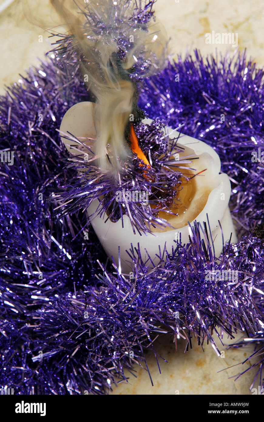 Candle catches fire to tinsel. Stock Photo