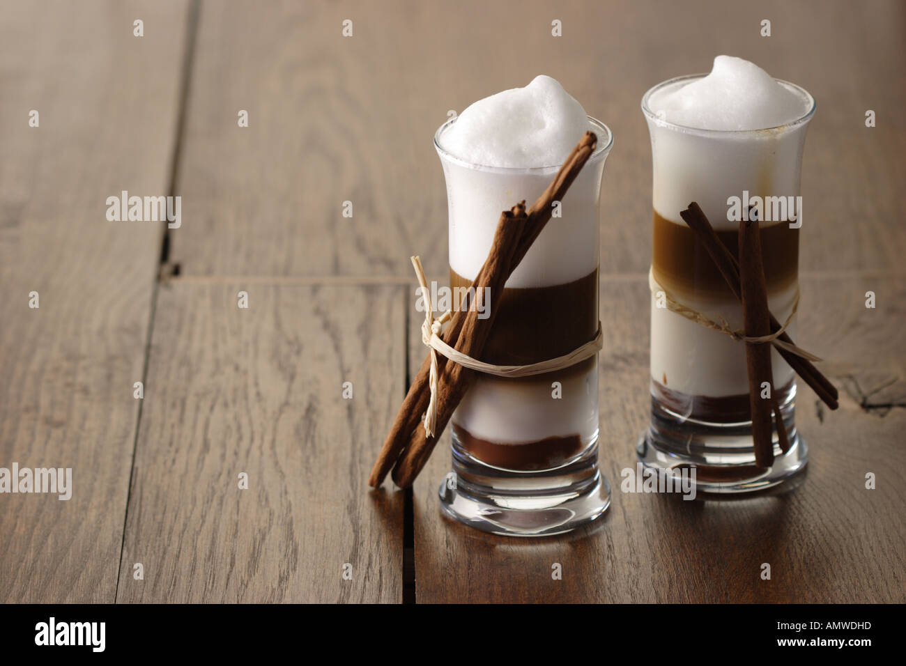 Two Latte Macchiato Nougat with cinnamon flavour and cinnamon sticks Stock Photo