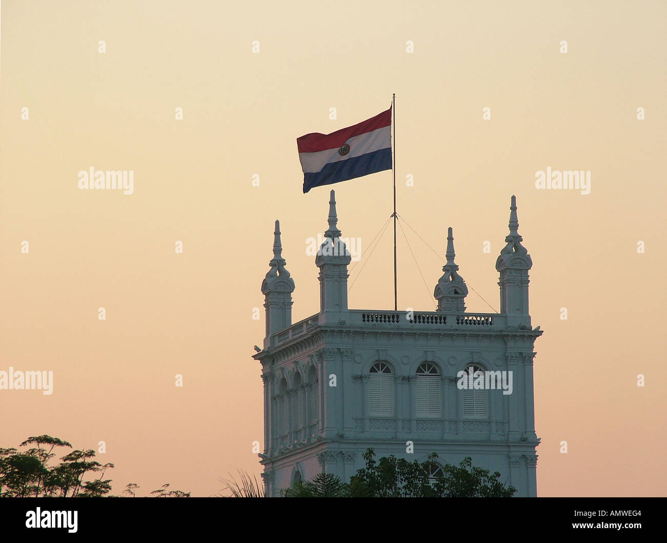 Paraguayan flag at the roof of the presidents palace at sun down Asuncion, Paraguay Stock Photo