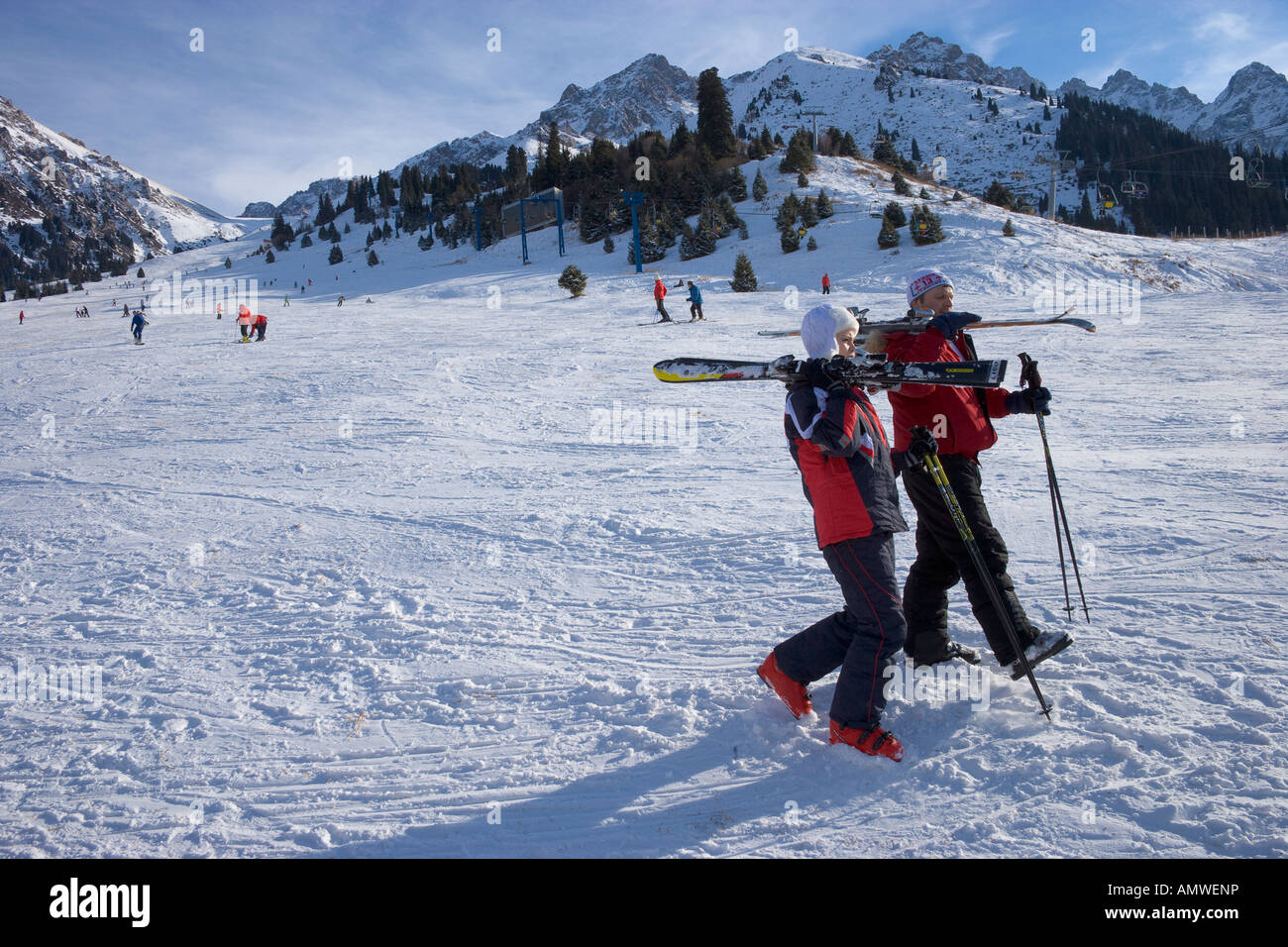Skiers walking snowy ski resort of Chimbulak Kazakhstan Stock Photo