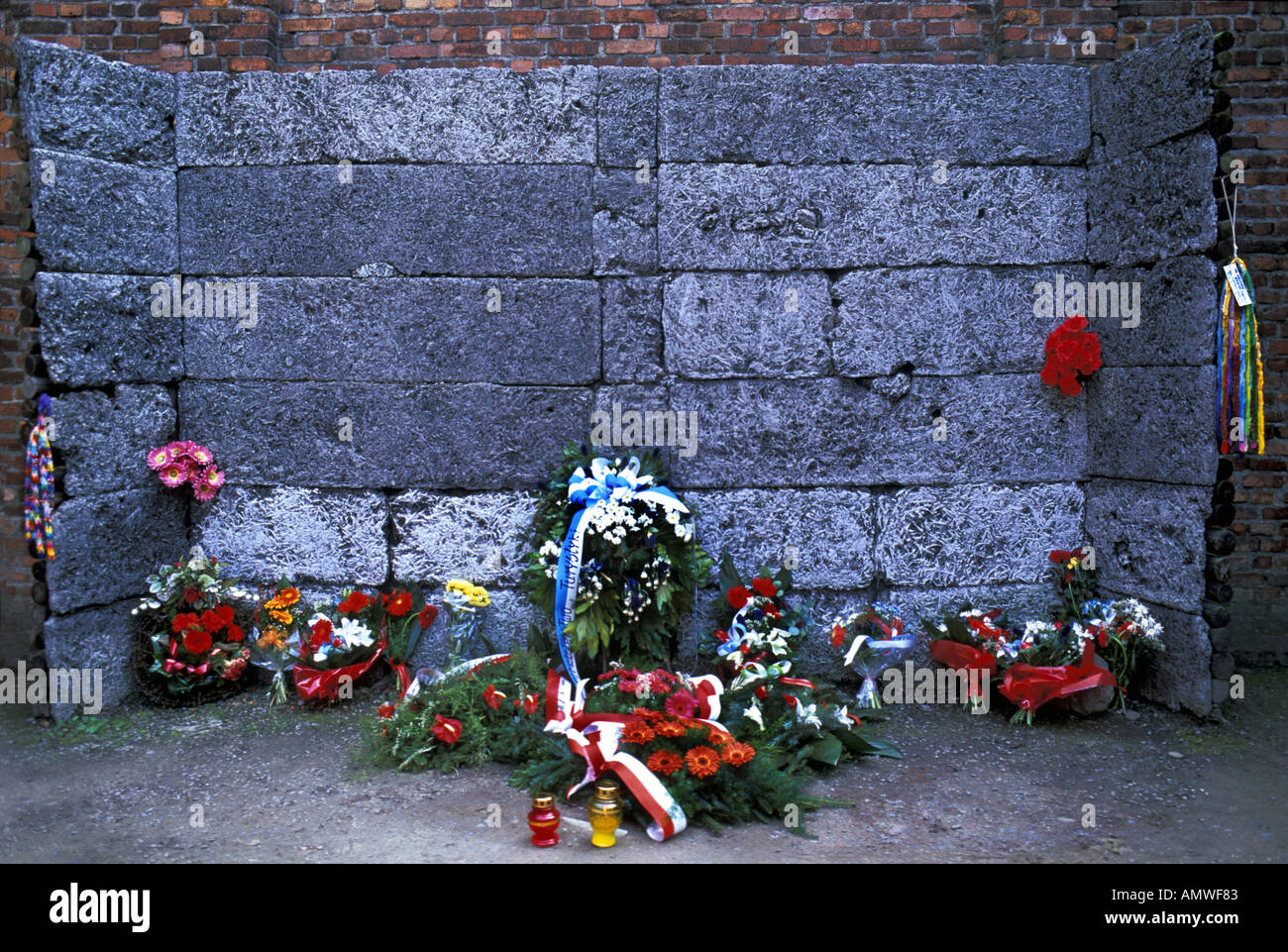 Auschwitz Concentration camp The Wall Of Death Flowers to commemorate the prsioners shot there by the Nazis Stock Photo