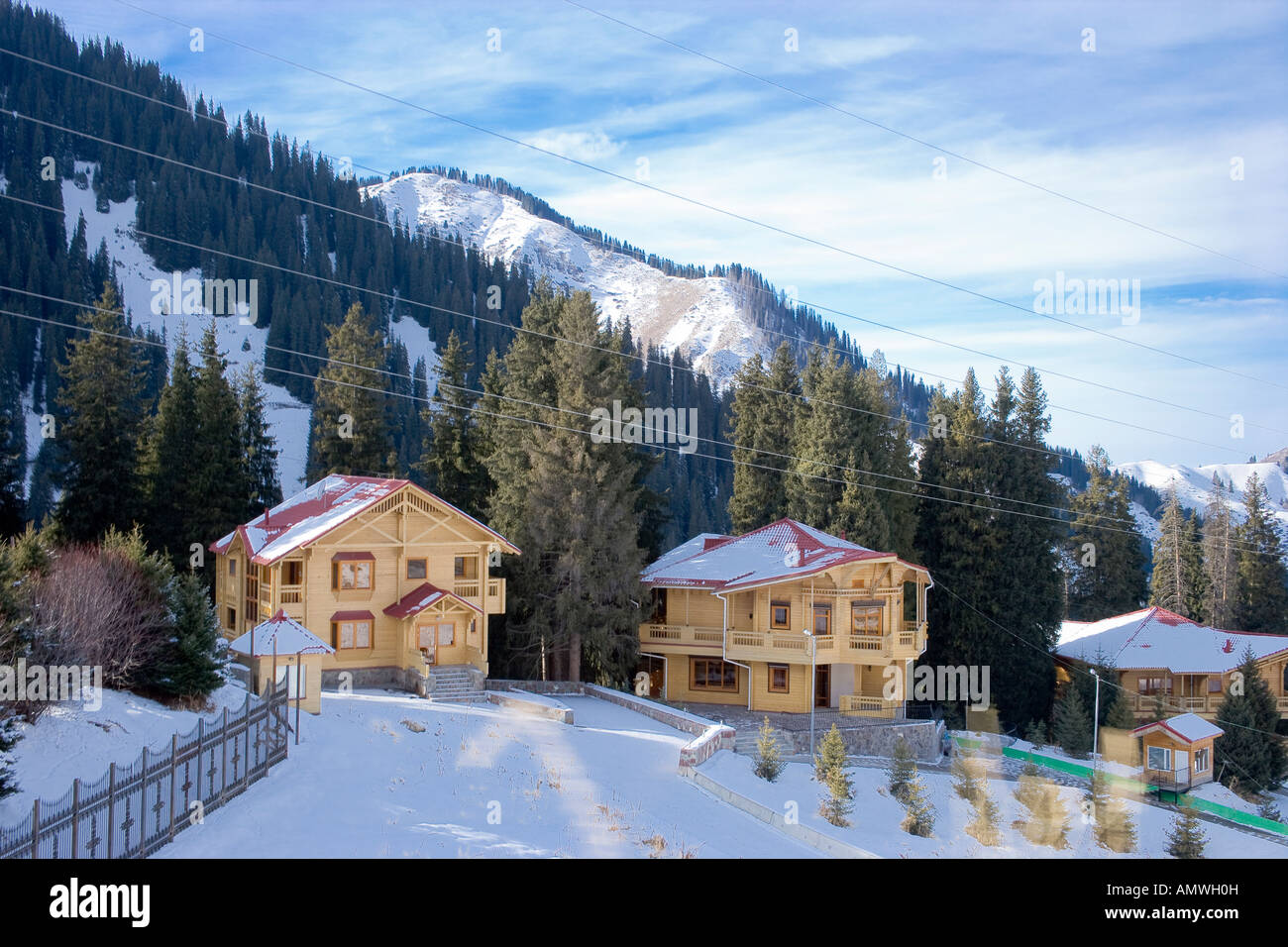 Wooden mountain lodges near snowy ski resort of Chimbulak Kazakhstan Stock Photo