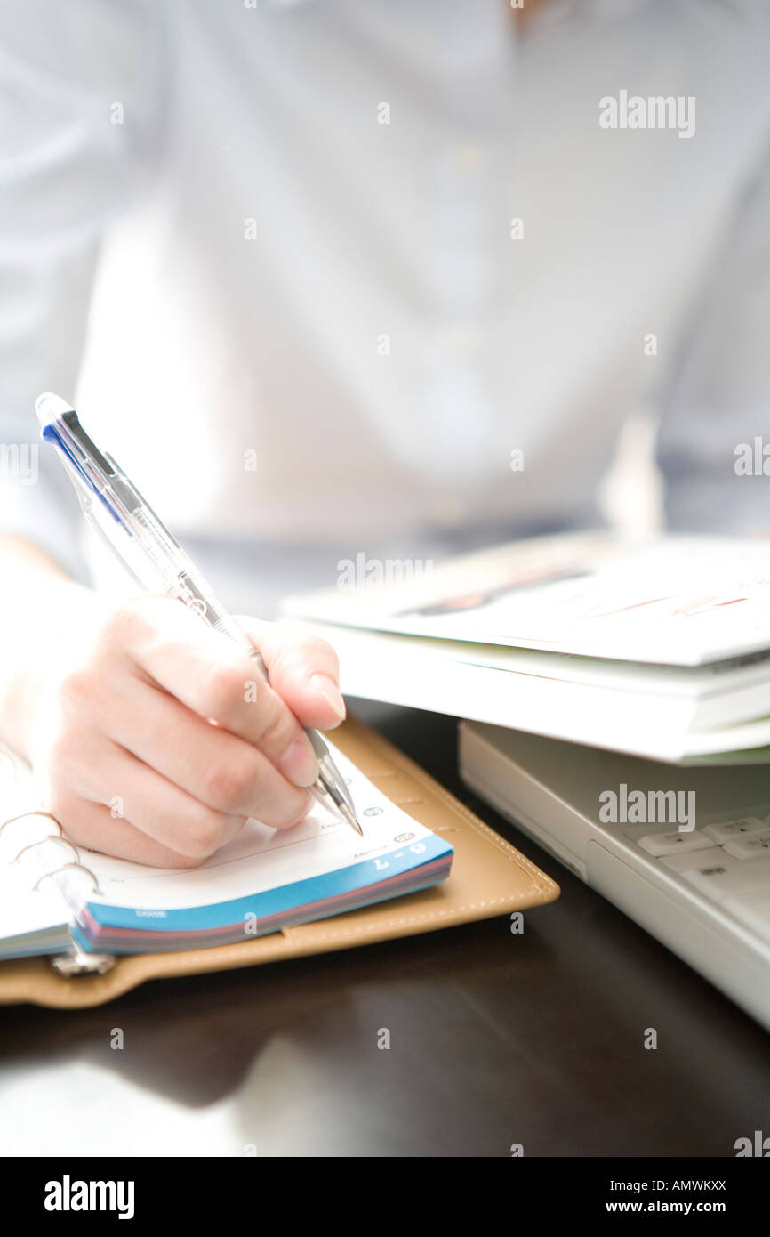 Hand taking note Stock Photo - Alamy