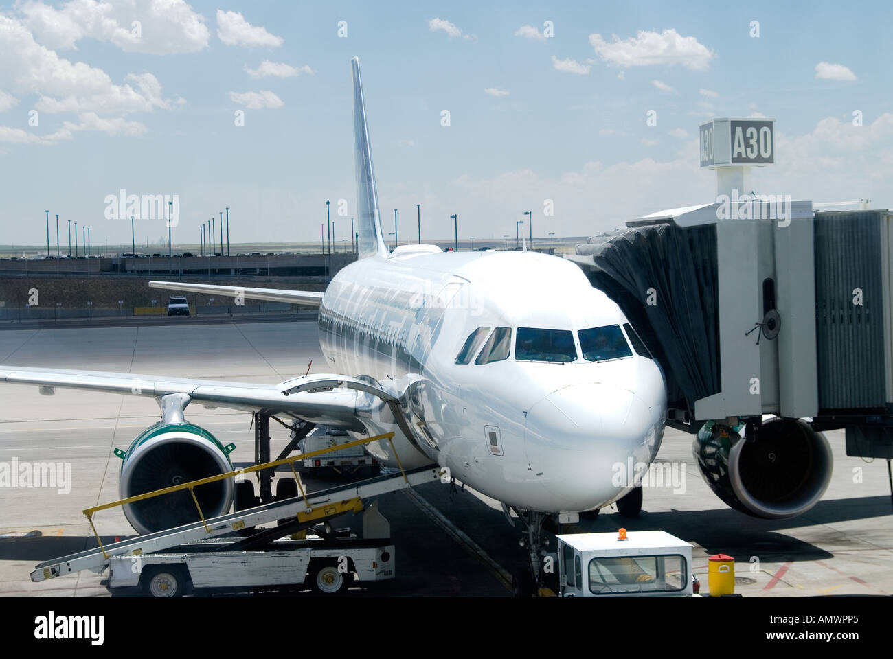 Passenger jet being loaded at Denver International Airport Stock Photo