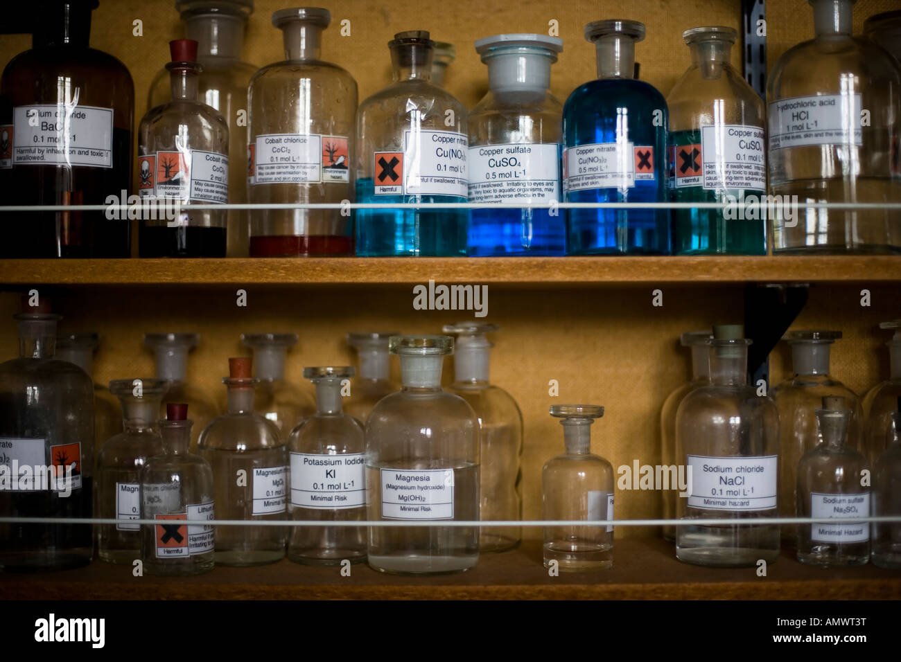 Glass storage jars containing chemicals in a school laboratory Stock