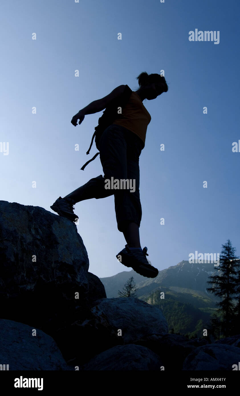 female mountain hiker in backlight, France, Alps Stock Photo - Alamy