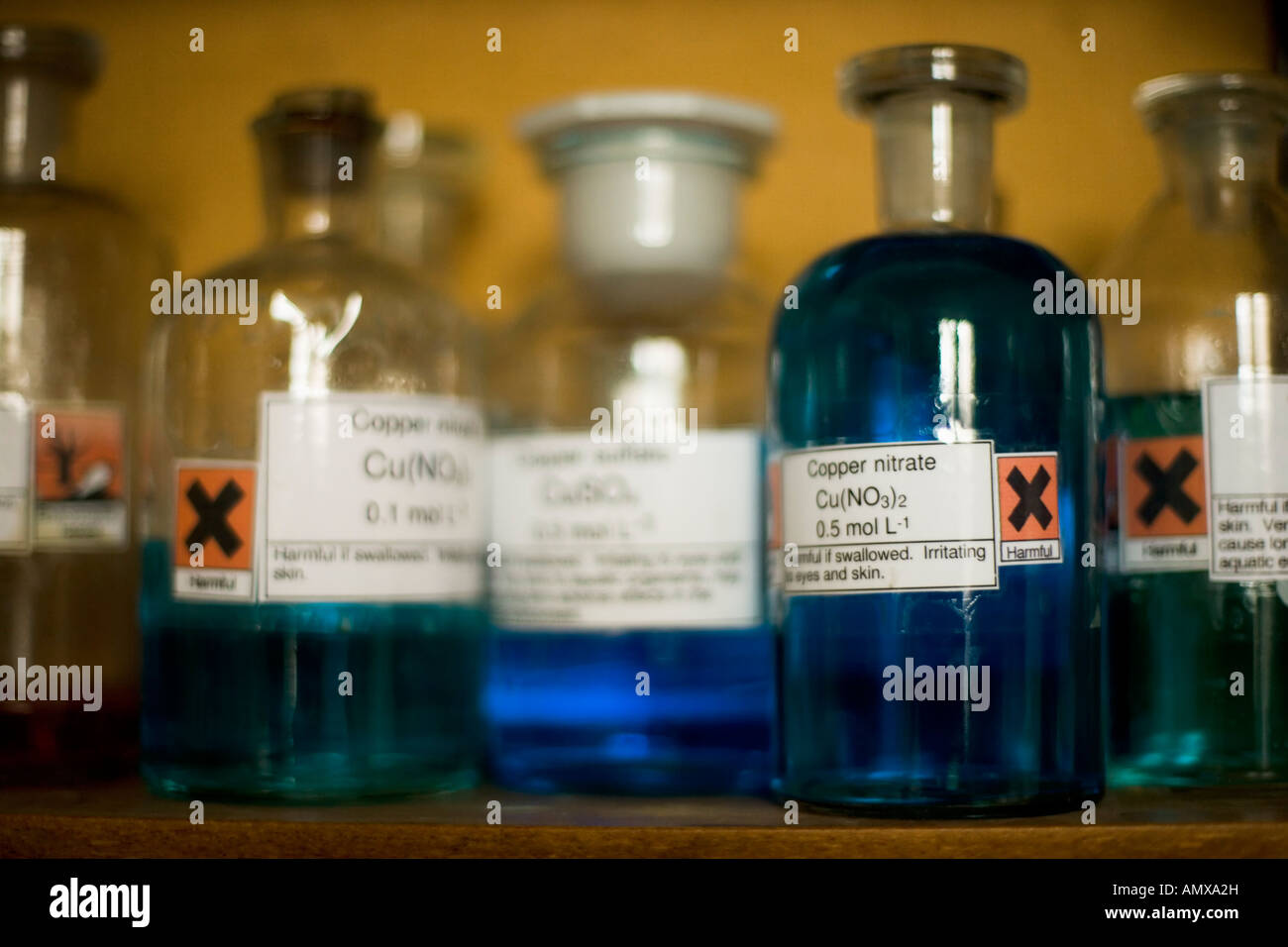 Glass storage jars containing chemicals in a school laboratory Stock