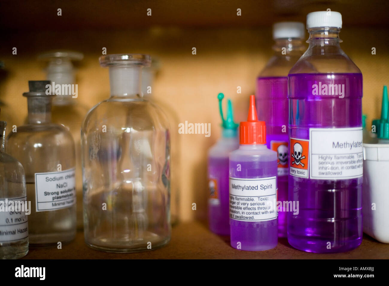 Glass storage jars containing chemicals in a school laboratory Stock
