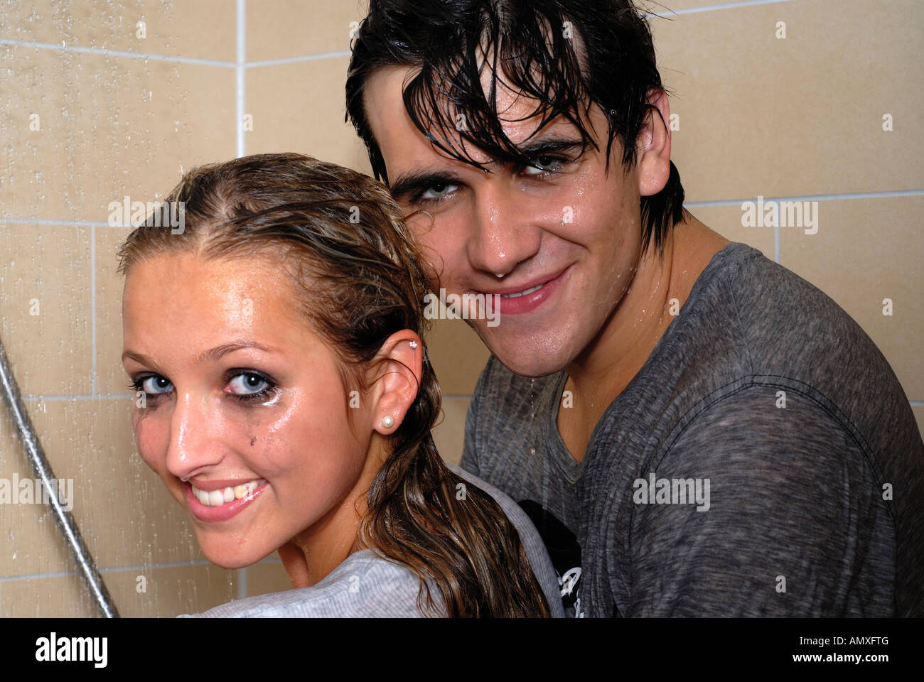 Couple dressed under shower  Stock Photo