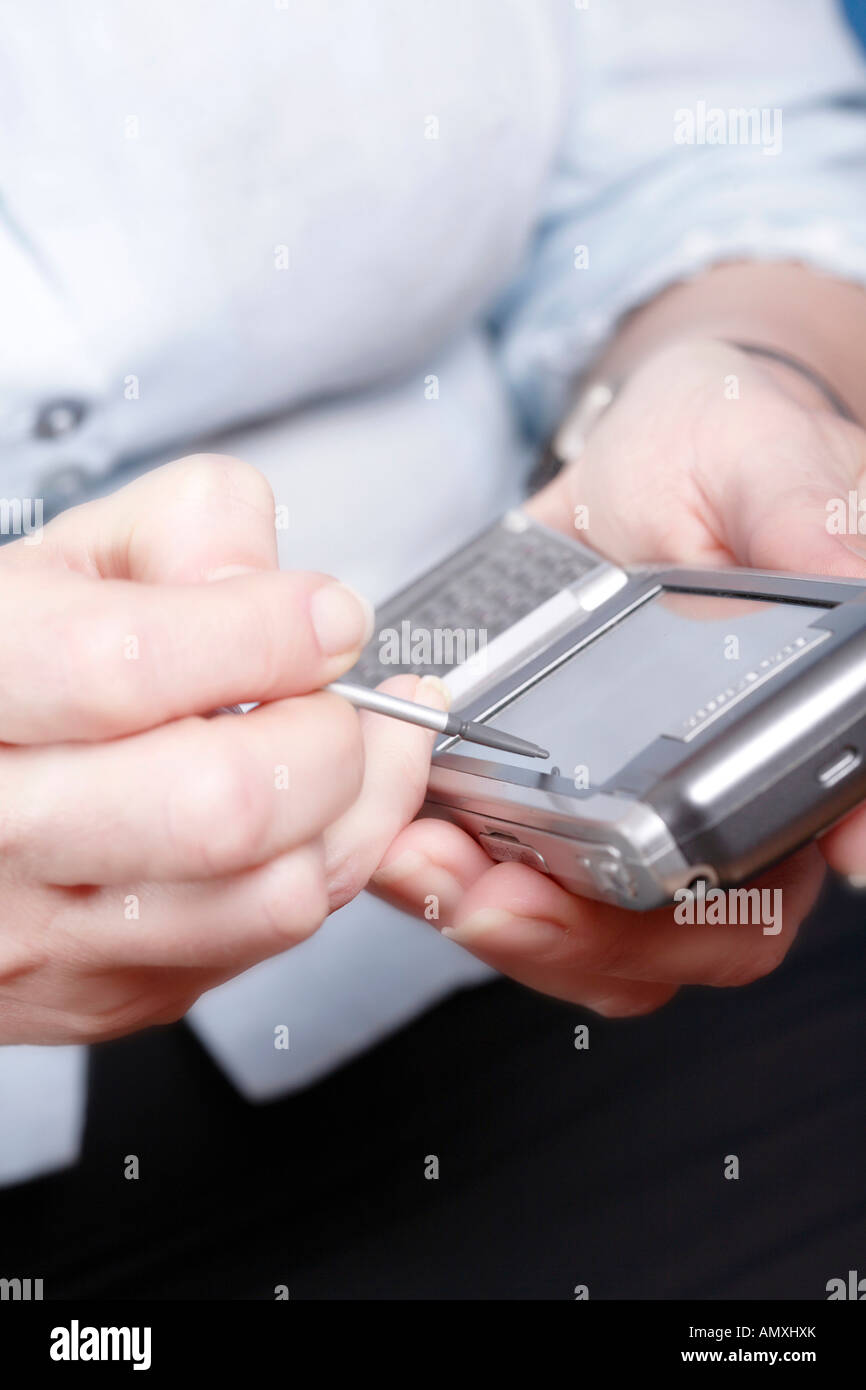 Close-up of woman's hands using palmtop Stock Photo