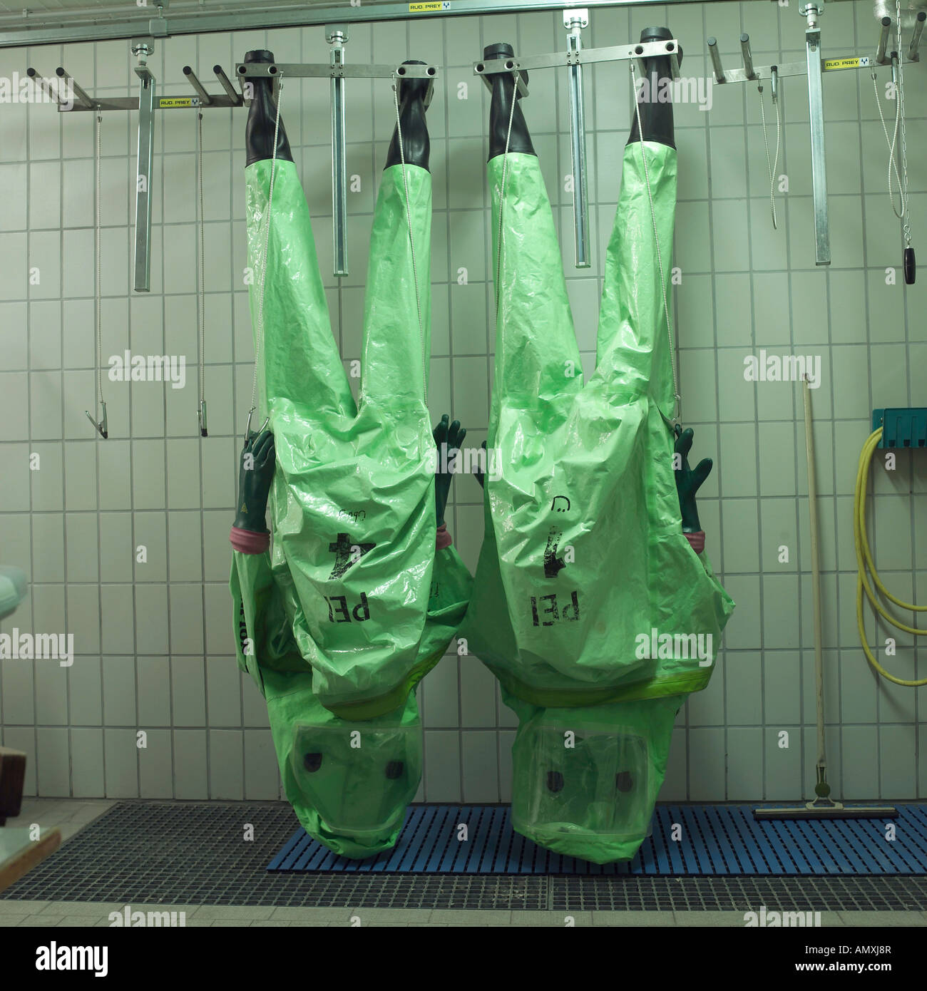 Firefighting protective gears hanging on hangers Stock Photo Alamy
