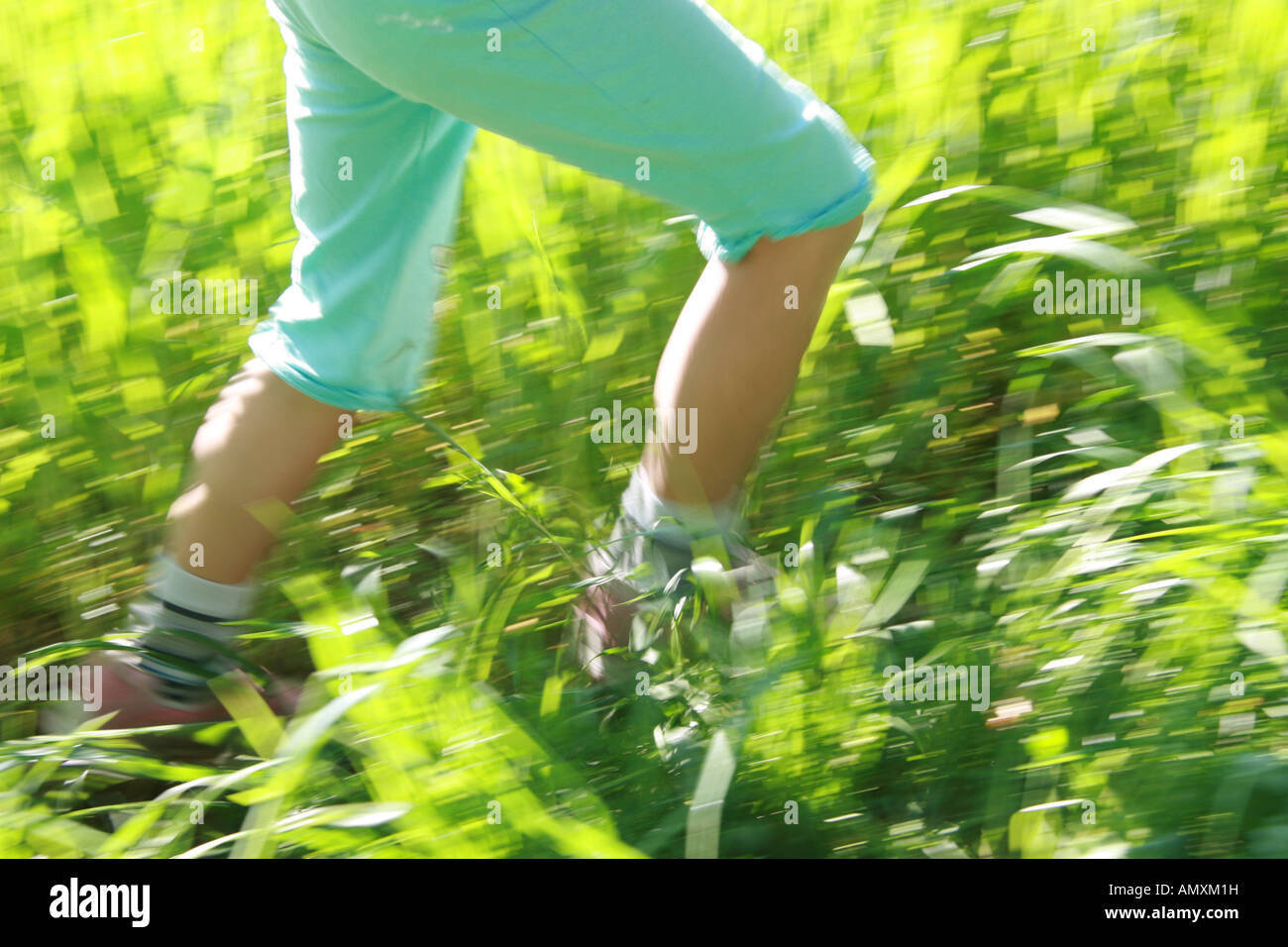 Low section view of child walking in field Stock Photo