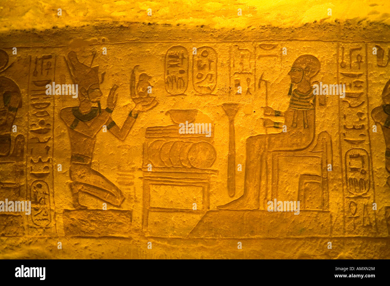 Carvings and wall paintings inside the Temple of Ramesses II at Abu Simbel Stock Photo