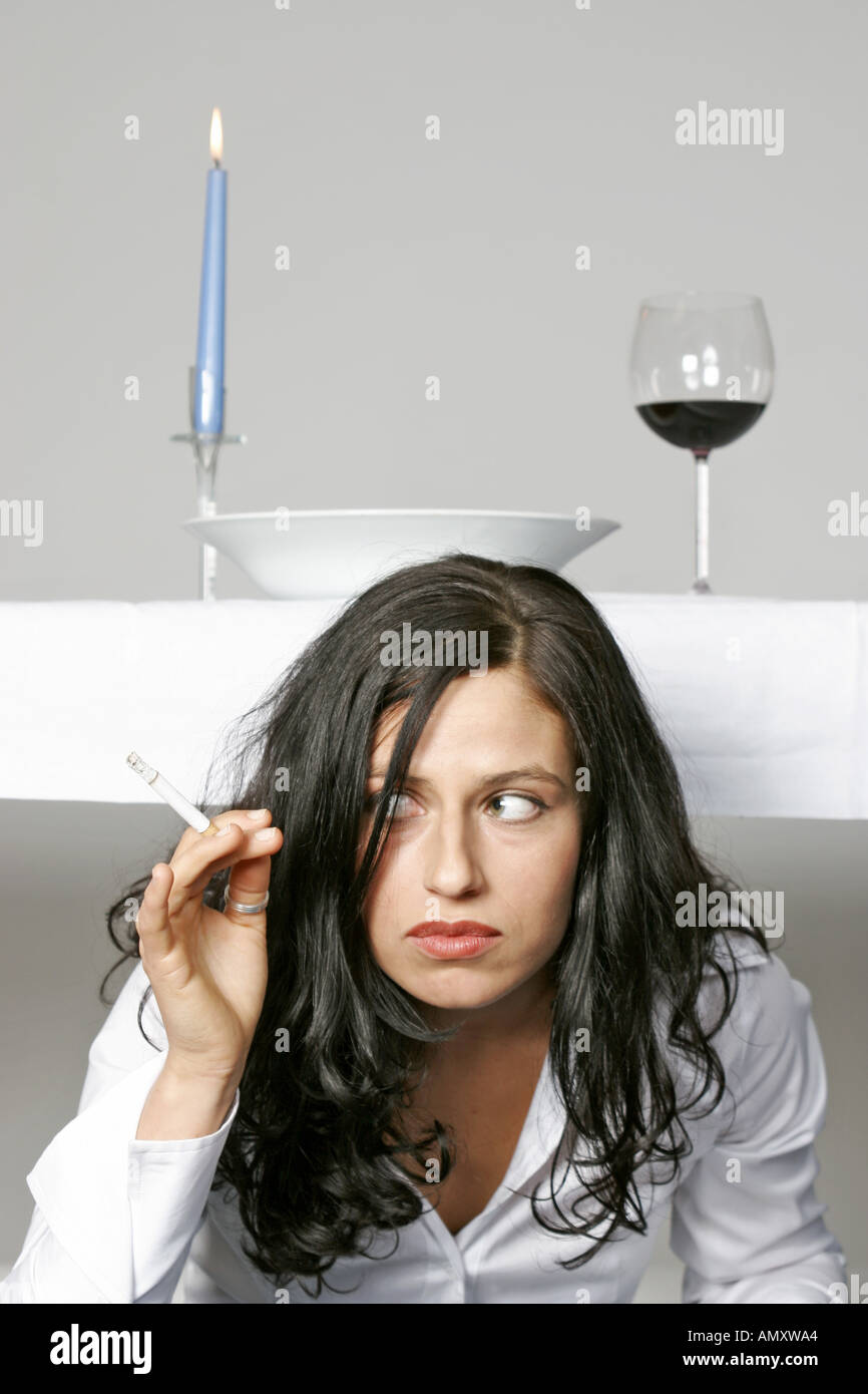 Young woman hiding smoking cigarette hires stock photography and images Alamy