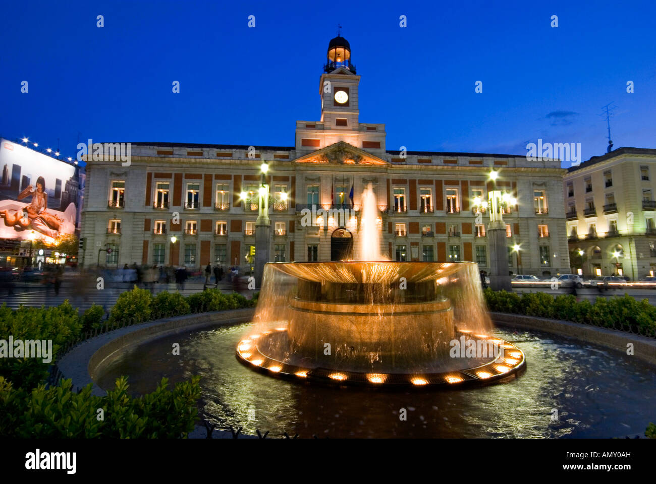 Fountain in front of building lit up at night, Puerta Del Sol, Madrid, Spain Stock Photo