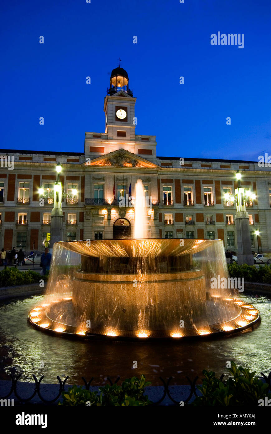 Fountain in front of building lit up at night, Puerta Del Sol, Madrid, Spain Stock Photo