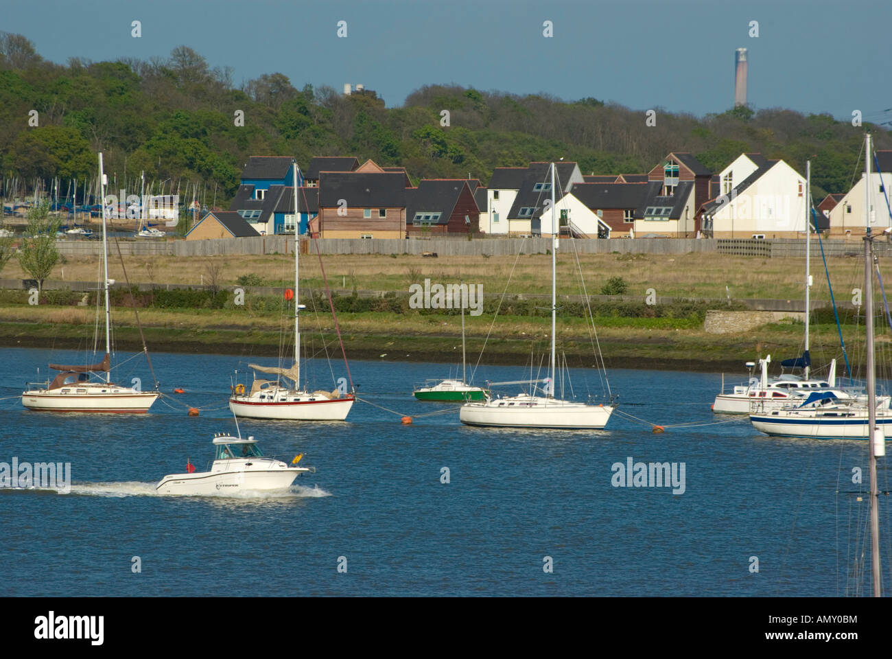 Boats in sea with houses in background, St Mary's Island, Chatham