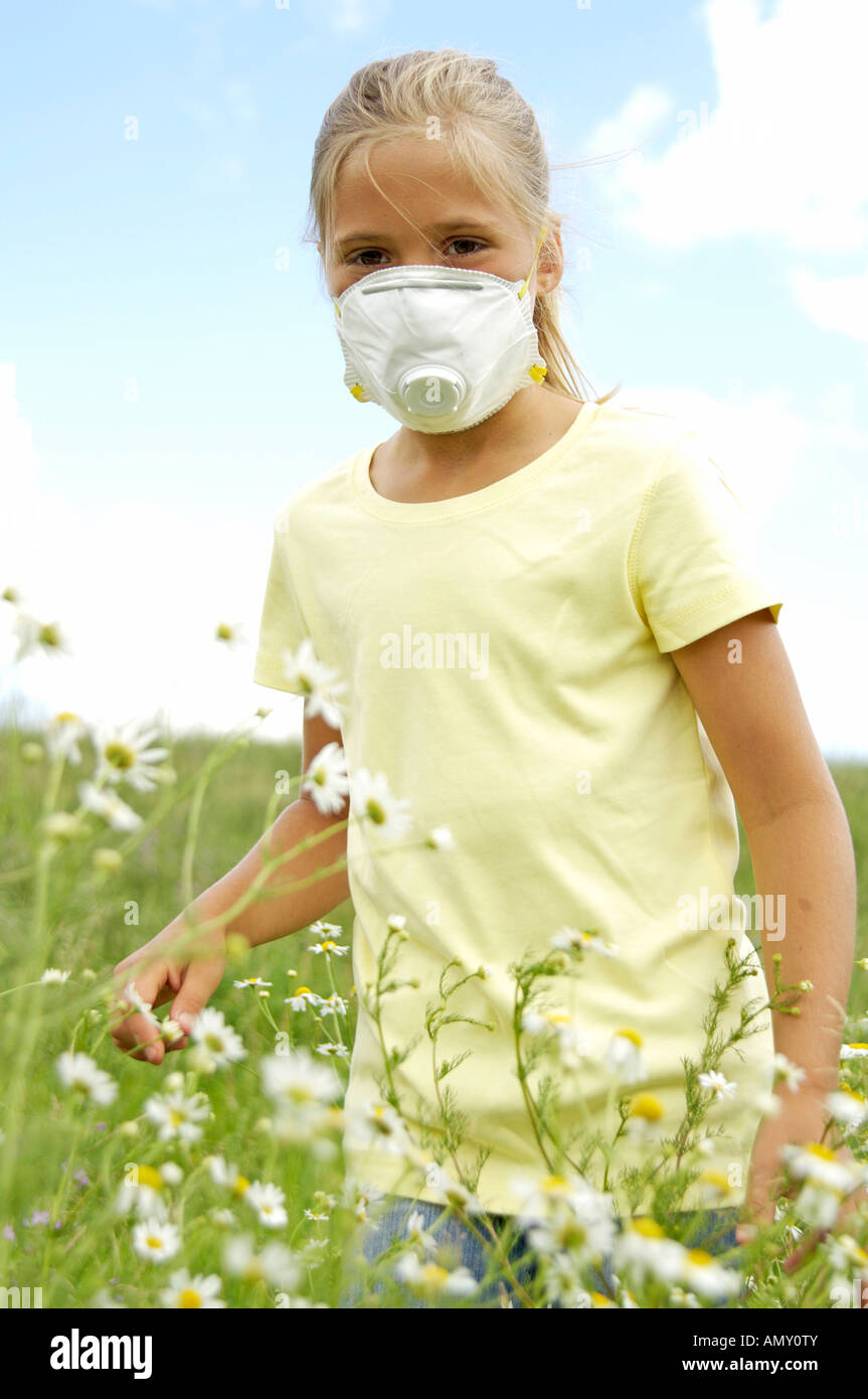Girl with mask standing in meadow Stock Photo - Alamy