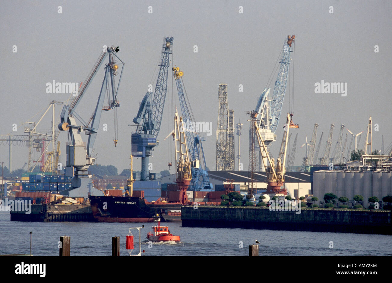 Cranes and container ship at port, Elbe River, Hamburg, Germany Stock Photo