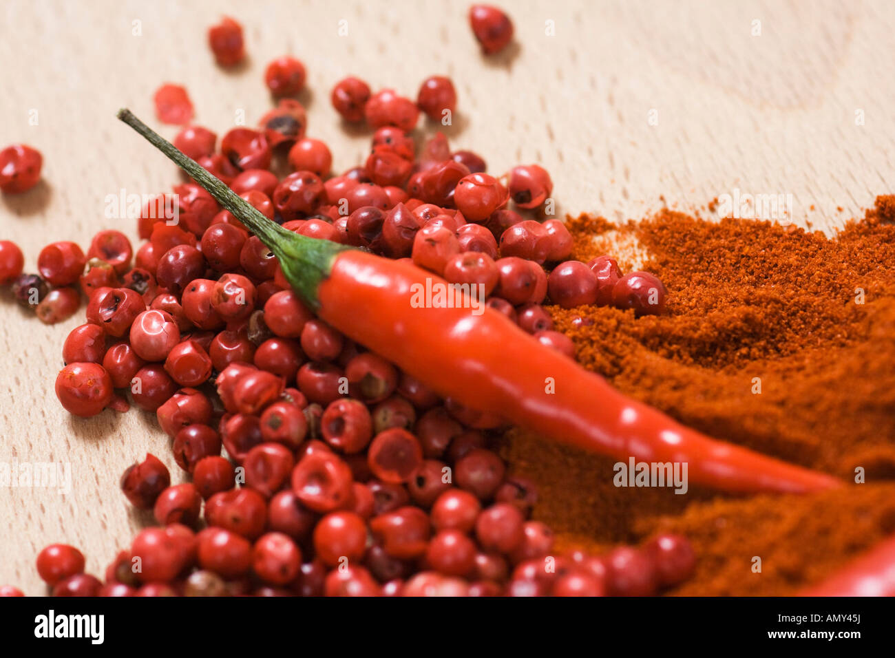 Close-up of chilli powder, red chilli pepper and peppercorns Stock Photo