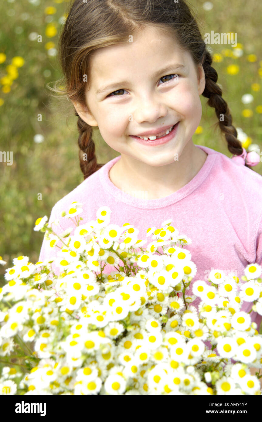 Portrait of girl holding bunch of flowers and smiling Stock Photo - Alamy