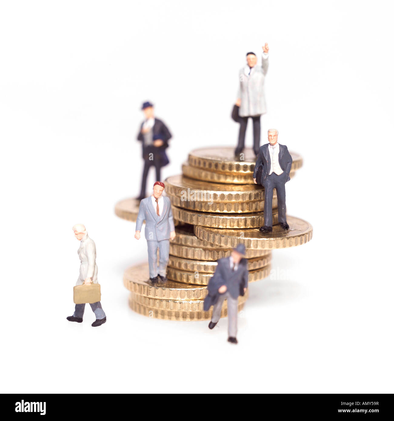 Figurines of businessmen with stack of coins Stock Photo - Alamy