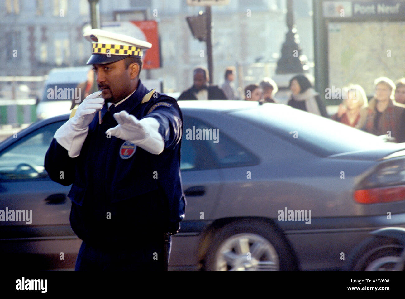 Paris traffic policement blowing whistle and signalling stop outside Pont Neuf Metro station Stock Photo