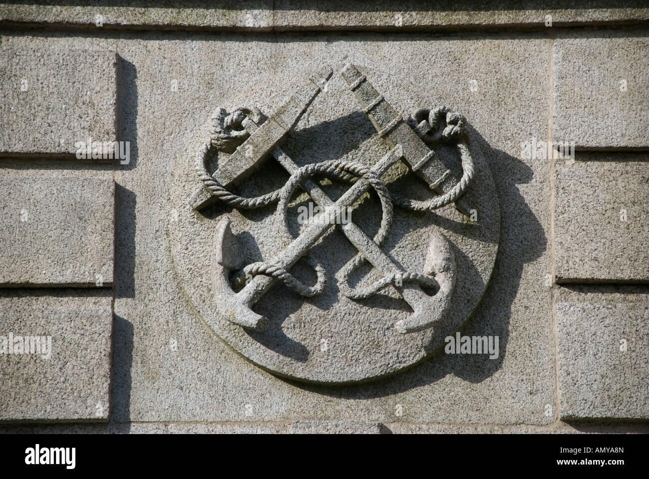 Stone carving of crossed anchors Stock Photo