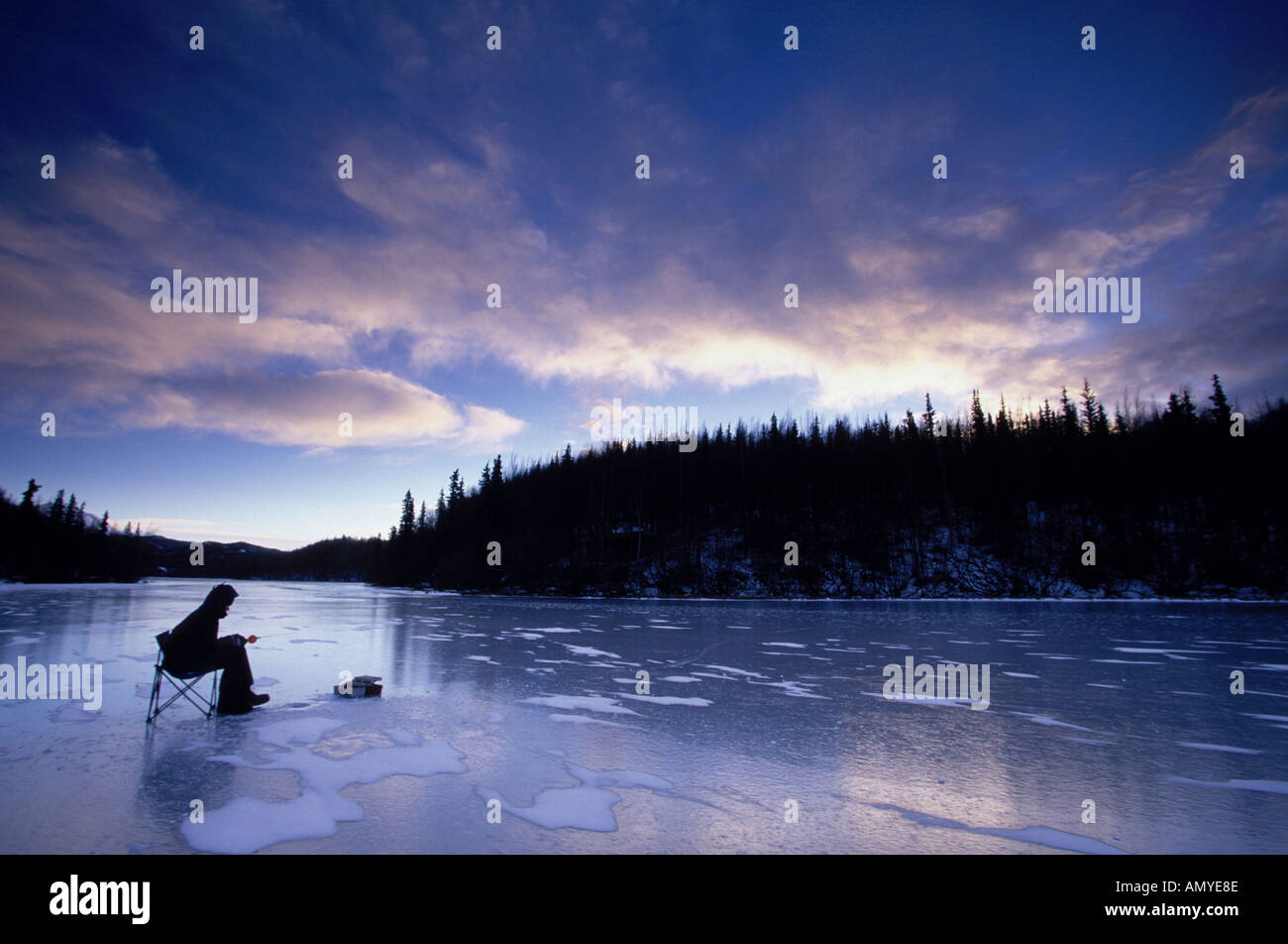 Man Ice Fishing on Long Lake SC Alaska Winter Stock Photo