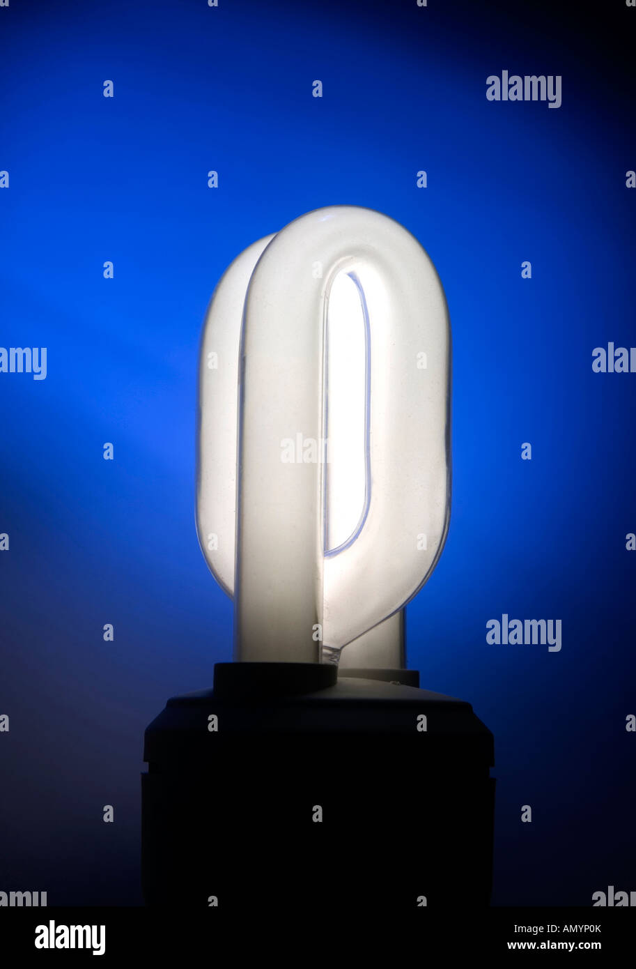Energy saving lightbulb on blue background Stock Photo - Alamy