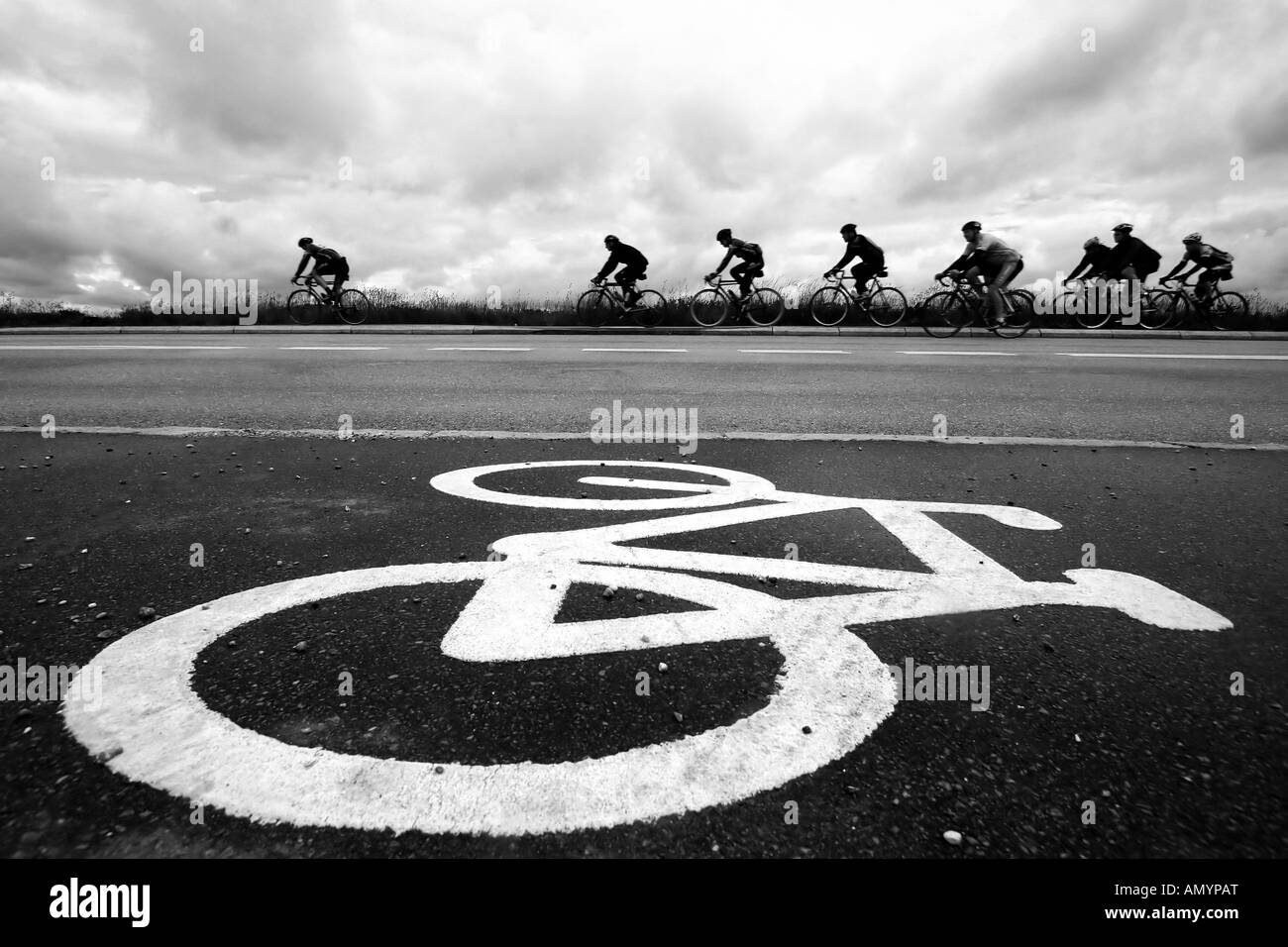 bike race in denmark cyclist are passing by a bike sign on the road Stock Photo