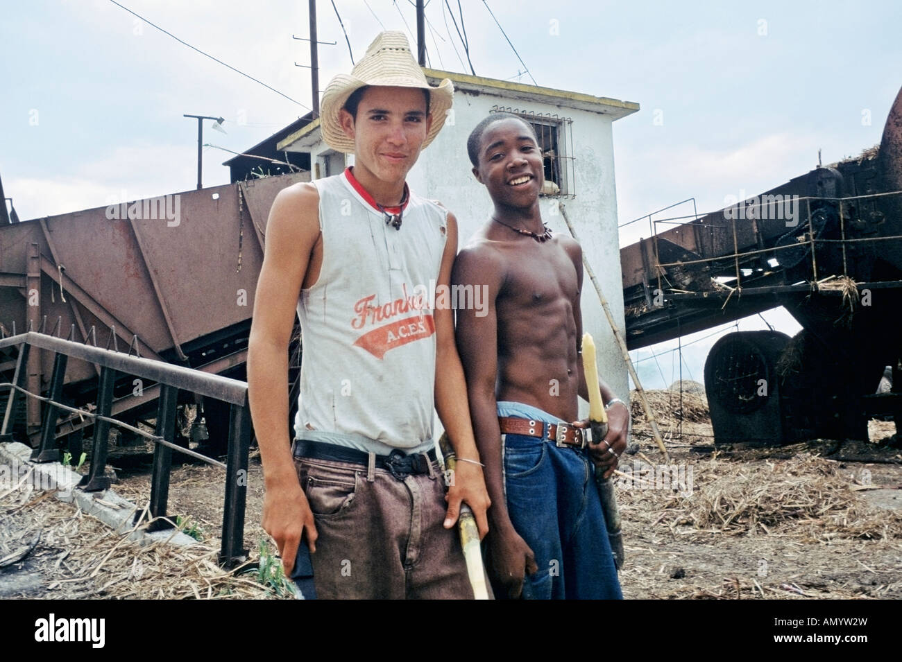 Two young workers at a sugar mill in Julio Reyes a sugar production town called a batey in the Province of Matanzas Cuba Stock Photo