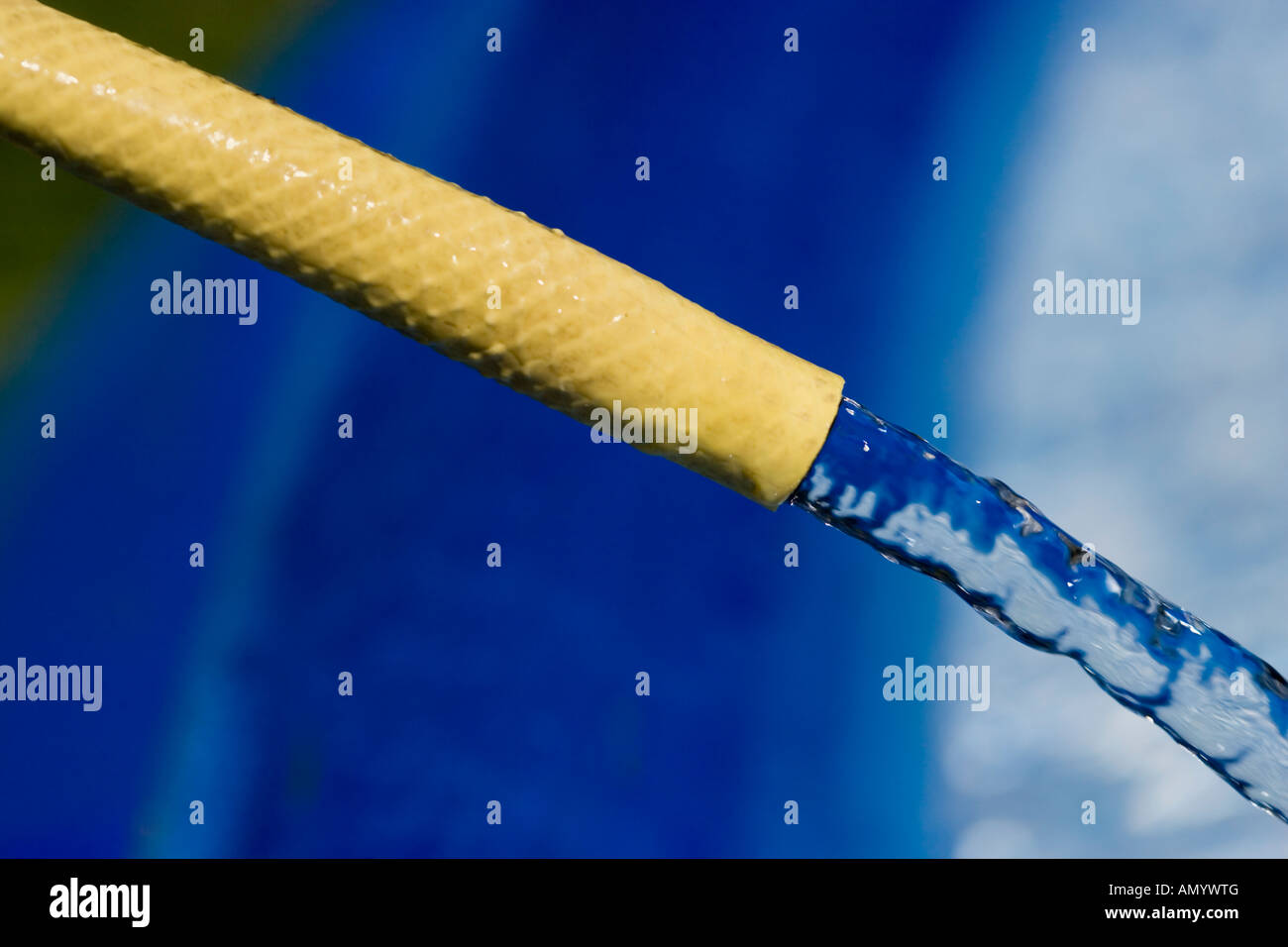 Yellow rubber hose pipe filling up a paddling pool Stock Photo Alamy