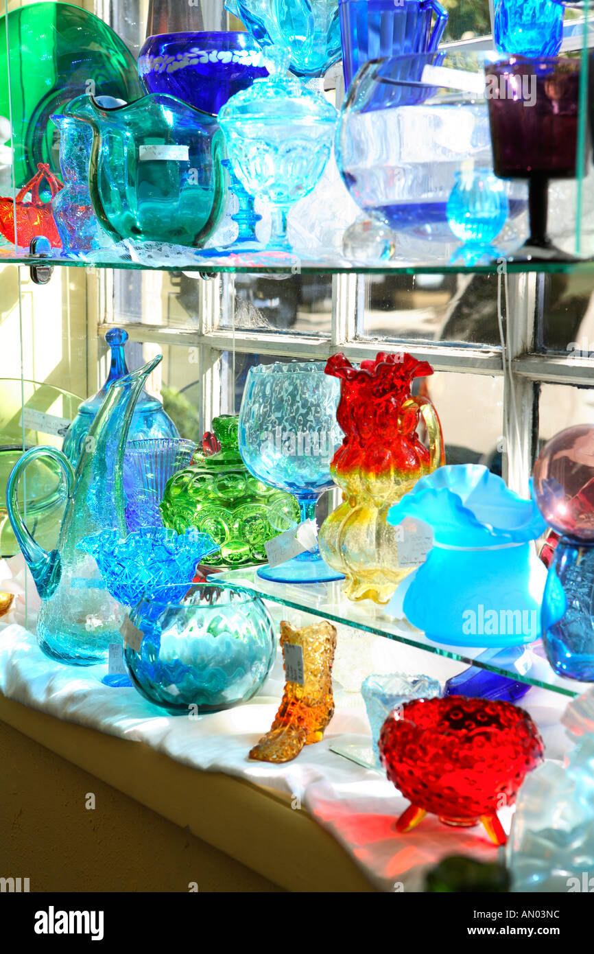 Shelves of colorful glass dishes on display in shop Stock Photo - Alamy