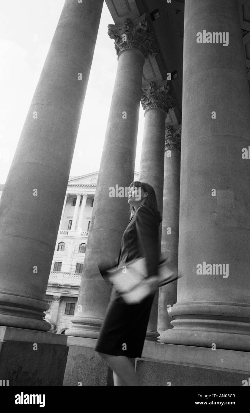 'LONDON BUSINESSWOMAN WALKING THROUGH COLONNADED ROYAL EXCHANGE BUILDING' Stock Photo